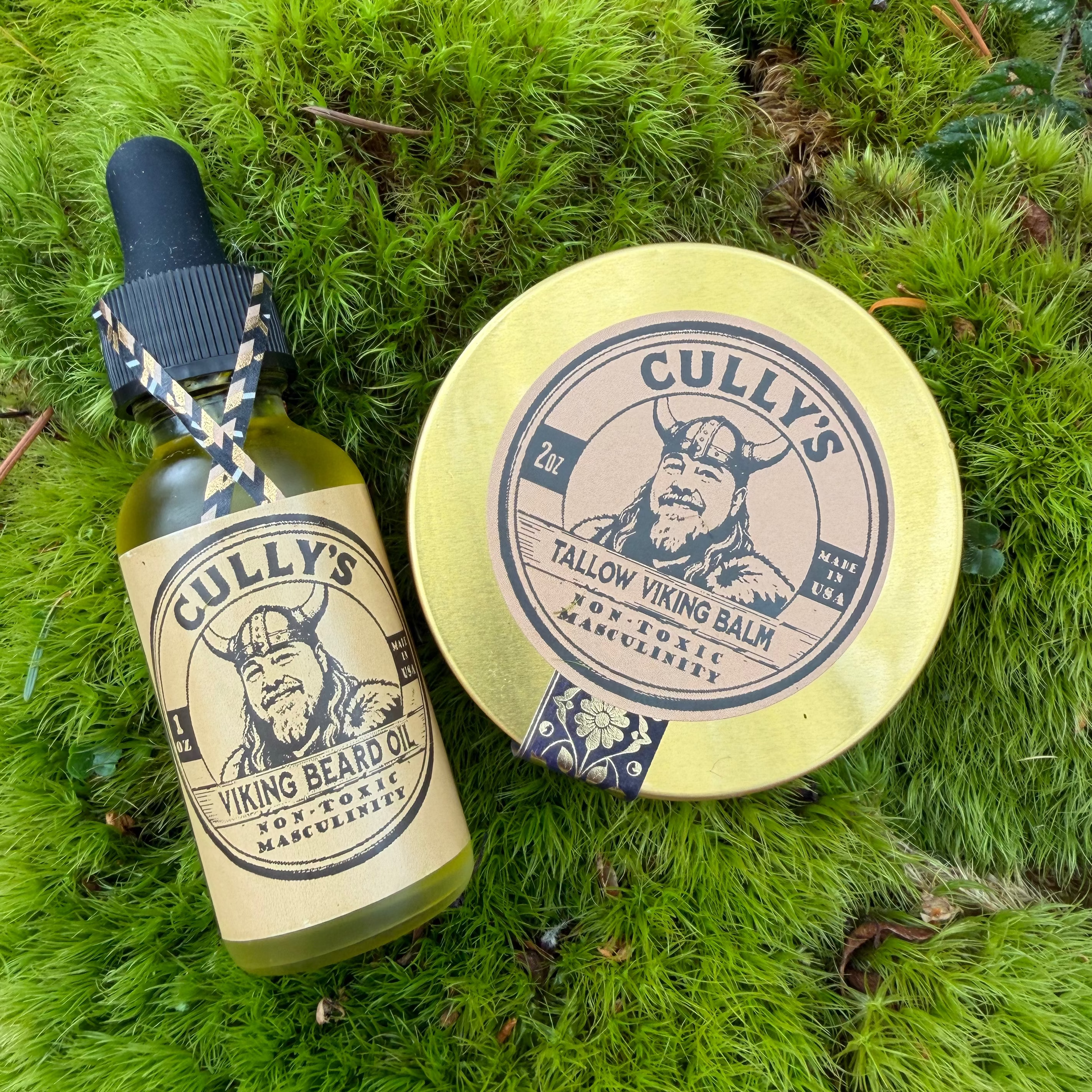Cully's Viking Beard Oil bottle and Tallow Viking Balm tin on green moss